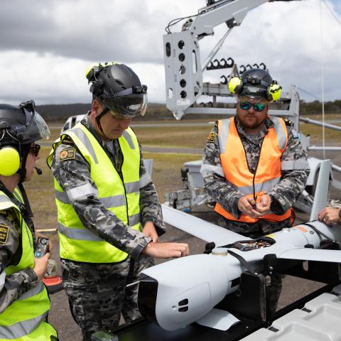 Leading Seaman Emma Searle, Chief Petty Officer Timothy Voight, Leading Seaman Garreth Laurie, and Leading Seaman Doug Thomas conduct pre-flight checks on a ScanEagle remotely piloted aircraft from 822X Squadron at Jervis Bay Airfield, Jervis Bay Territory. (Royal Australian Navy)