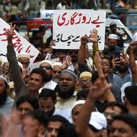 A trader holds a placard reading "prevent unemployment from rising" during a protest in Karachi, Pakistan, on August 23, 2023. (Asif Hassan/AFP via Getty Images)