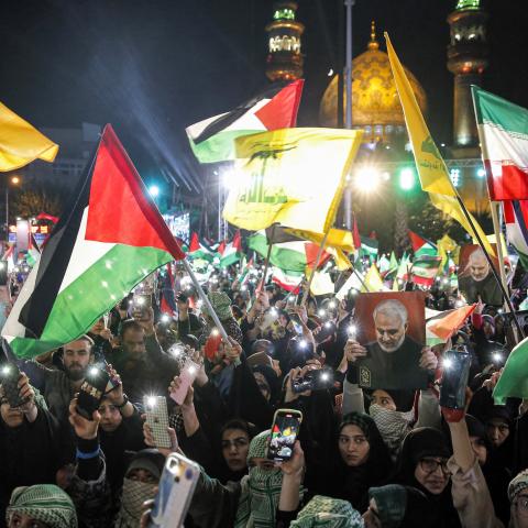 Demonstrators gather with Iranian and Palestinian flags and the yellow flags of the Lebanese Shiite movement Hezbollah during a protest in Tehran in support of Palestinians in the Gaza Strip on October 20, 2023. (AFP via Getty Images)