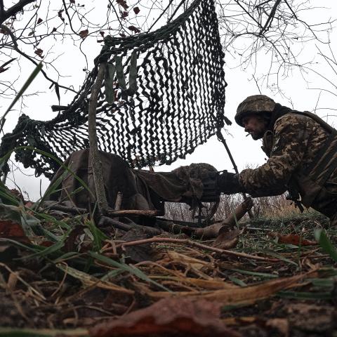 A Ukrainian military man shoots from a trophy AGS-17 on October 27, 2023 in the Bakhmut district of Ukraine. Ukrainian forces continue to fight to retake Bakhmut, which was captured by Russian forces in May, following a yearlong battle. Over the summer, Ukraine regained territory north and south of Bakhmut but Russia has held the city itself. (Photo by Kostya Liberov / Libkos via Getty Images)