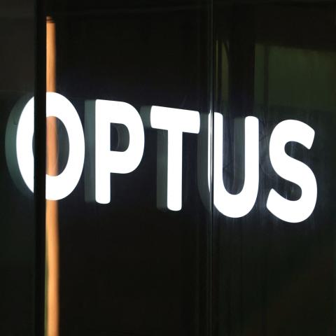 An illuminated sign is displayed in the window of an outlet for the Australian communications company Optus in Sydney on November 9, 2023. Australia's government on November 9 launched an investigation into a nationwide communications outage that crippled phone lines and severed internet access for 10 million customers countrywide. (Photo by DAVID GRAY / AFP) (Photo by DAVID GRAY/AFP via Getty Images)