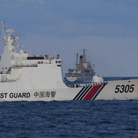 A Chinese Coast Guard ship sails near a Philippine vessel that was part of a convoy of civilian boats in the disputed South China Sea on December 10, 2023. (Photo by Ted Aljibe via Getty Images)