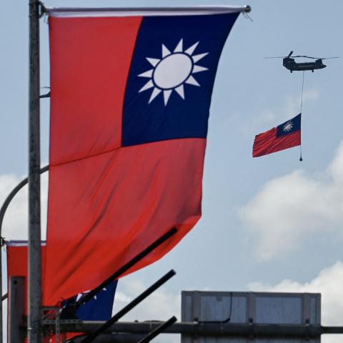A CH-47 Chinook helicopter carries a Taiwan flag during National Day celebrations in Taipei on October 10, 2021. (Sam Yeh/AFP via Getty Images)