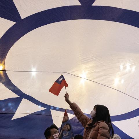 Supporters cheer under a huge flag of Taiwan during an election campaign rally of Kuomintang (KMT) presidential candidate Hou Yu-ih in New Taipei City on January 12, 2024. (Photo by ALASTAIR PIKE / AFP) (Photo by ALASTAIR PIKE/AFP via Getty Images)