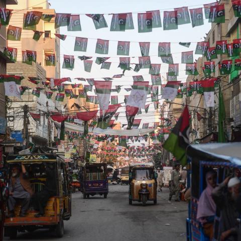 Commuters move past the Pakistan People's Party flags hung over a street in Karachi on January 16, 2024, ahead of the country's upcoming general elections. (Asif Hassan/AFP via Getty Images)