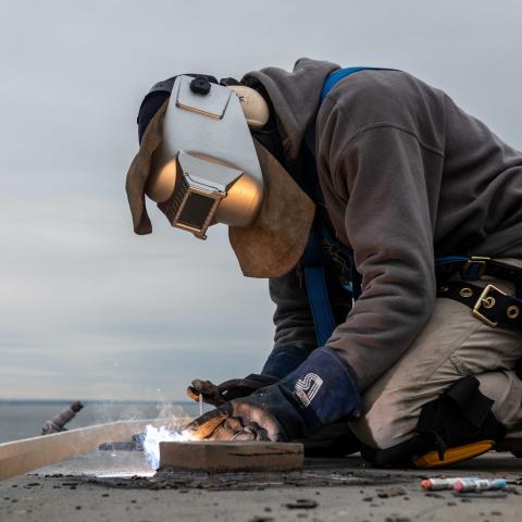 A contractor welds on the flight deck aboard the aircraft carrier USS John C. Stennis (CVN 74), in Norfolk, Virginia, on January 21, 2014. (US Navy photo by Mass Communication Specialist Seaman Crayton Agnew)