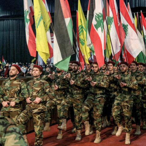 Pro-Iranian Hezbollah militants march with Lebanese, Palestinian, and Hezbollah flags during a mass rally to mark al-Quds Day (Jerusalem Day). (Marwan Naamani/picture alliance via Getty Images)