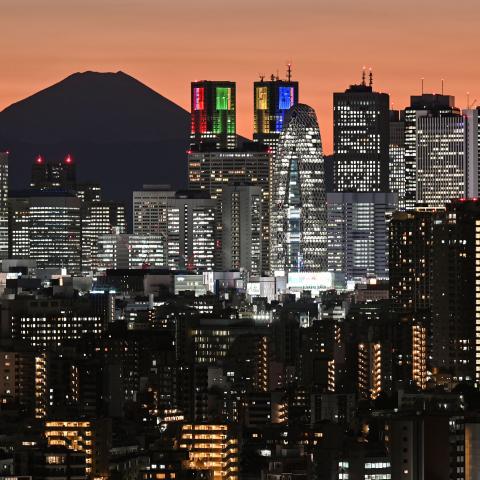 Mount Fuji is silhouetted during sunset behind the high-rise buildings of the Shinjuku area in downtown Tokyo on November 20, 2023. (Photo by Richard A. Brooks/AFP via Getty Images)