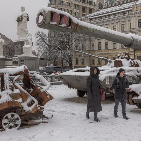 Pedestrians walks past destroyed Russian military vehicles blanketed in snow in front of Saint Michael's Golden-Domed Monastery in downtown Kyiv on November 22, 2023. (Roman Pilpey/AFP via Getty Images)