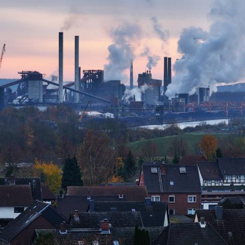 In this aerial view water vapor and exhaust rise from the steel mill of Salzgitter AG, one of Europe's largest steel producers, as residential buildings stand nearby on November 22, 2023 in Salzgitter, Germany. (Sean Gallup via Getty Images)
