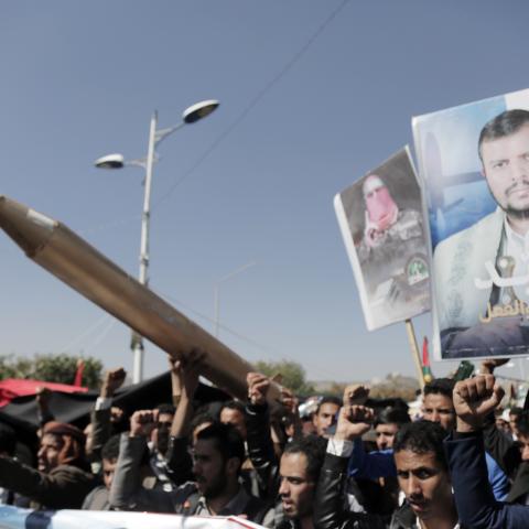 Yemenis lift a Palestinian flag and placards depicting Houthi group leader Abdul-Malik Badreddin al-Houthi and Abu Obaida, the spokesperson of Hamas' armed wing, on January 24, 2024, in Sana'a, Yemen. (Photo by Mohammed Hamoud/Getty Images)