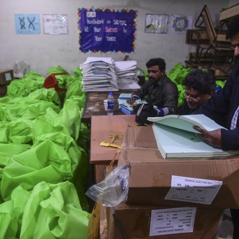 Pakistan election commission workers prepare election materials at a distribution center in Karachi on February 6, 2024. (Asif Hassan/AFP via Getty Images)