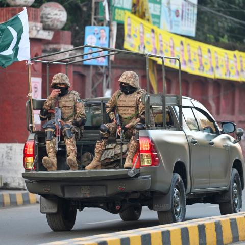 Military troops patrol near a polling station during Pakistan's national elections in Lahore on February 8, 2024. (Aamir Qureshi/AFP via Getty Images)