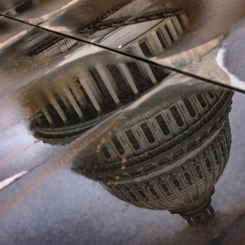 The US Capitol building is seen reflected in rain puddles on February 11, 2024, in Washington, DC. (Samuel Corum via Getty Images)