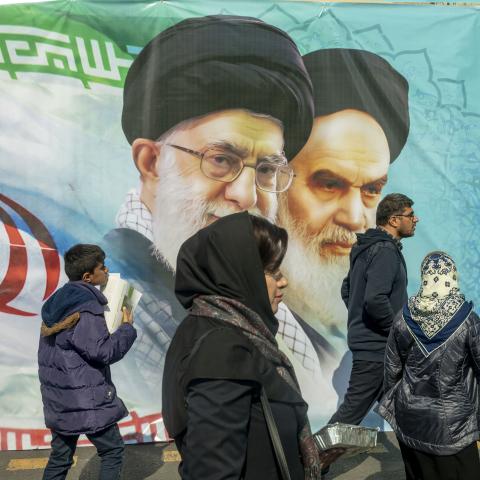 Iranians attend an annual rally commemorating the 1979 Islamic Revolution with portraits of Iranian Leaders in the background on February 11, 2024, in Tehran, Iran. (Photo by Majid Saeedi/Getty Images)