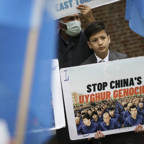 A boy protests China's genocide against the Uyghurs at a demonstration in Washington, DC, on April 16, 2021. (Photo by Drew Angerer/Getty Images)