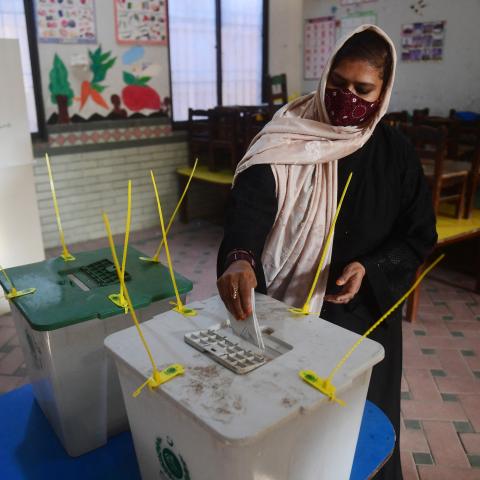 A woman casts her ballot to vote at a polling station during Pakistan's national elections in Karachi on February 8, 2024. (Photo by Asif Hassan/AFP via Getty Images)