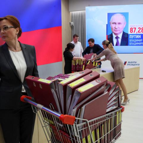 A screen displays a portrait of re-elected Russian President Vladimir Putin following the announcement of the official results in the three-day presidential election at Russia's Central Electoral Commission (CEC) in Moscow on March 21, 2024. (Stringer via Getty Images)