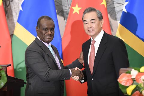 Solomon Islands Foreign Minister Jeremiah Manele shakes hands with Chinese Foreign Minister Wang Yi to mark the establishment of diplomatic ties between the two nations in September, 2019 in Beijing, China. (Naohiko Hatta via Getty Images)