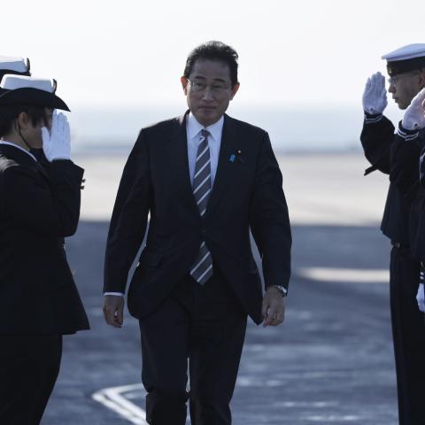 Japanese Prime Minister Fumio Kishida is saluted by members of the Japan Maritime Self-Defence Force during an International Fleet Review on November 6, 2022, off Yokosuka, Japan. (Photo by Issei Kato/Pool/Getty Images)