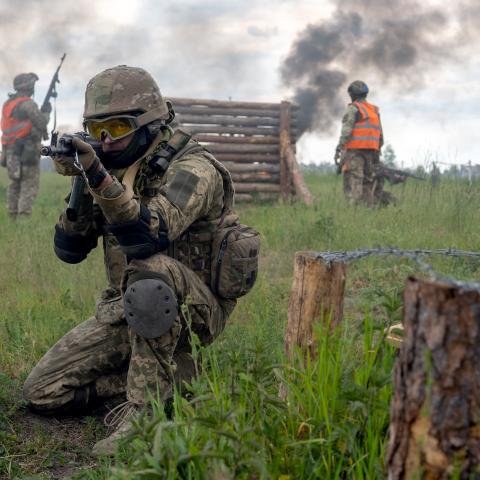 A soldier aims a rifle during a military drill in Kyiv Region, Ukraine. (Ukrinform via Getty Images)