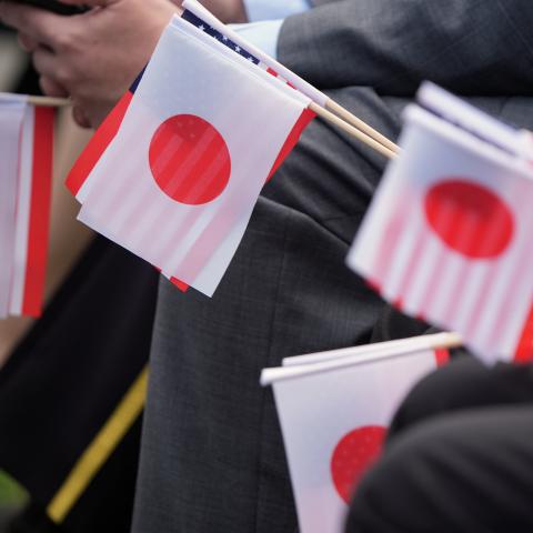 Guests hold Japanese and American flags as they wait for the arrival ceremony for Prime Minister Fumio Kishida and Mrs. Yuko Kishida of Japan at White House on April 10, 2024 in Washington, DC.  ( Andrew Harnik via Getty Images)