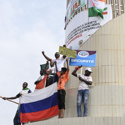 Protestors hold Russian and Chinese flags in Niamey, Niger, on August 20, 2023. (Photo by AFP via Getty Images)