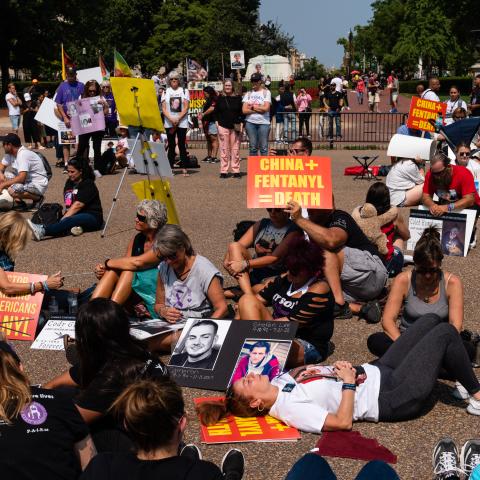 Demonstrators sit during a moment of silence at a rally against fentanyl near the White House in Washington, DC, on September 17, 2022. (Eric Lee for The Washington Post via Getty Images)
