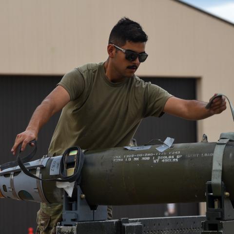 An airman unstraps an inert Joint Direct Attack Munition (JDAM) during the Lone Star Challenge at Dyess Air Force Base, Texas, on July 13, 2023. (US Air Force photo)
