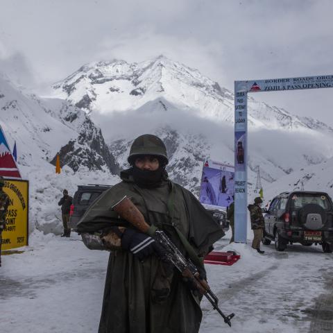 Indian soldiers stand guard at the Srinagar-Leh Highway on March 19, 2022, in Kashmir, India. (Yawar Nazir/Getty Images)