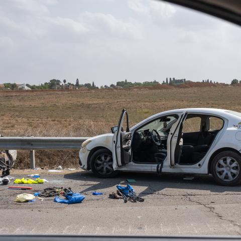 : A baby stroller, along with other personal belongings are left on the side of the road
