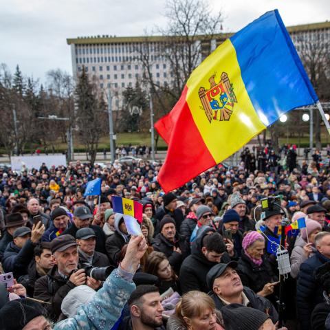 Moldovans hold national flags at a rally in the courtyard of Moldovan presidential headquarters in Chisinau, Moldova, on December 17, 2023. (Photo by Elena Covalnco/AFP via Getty Images)