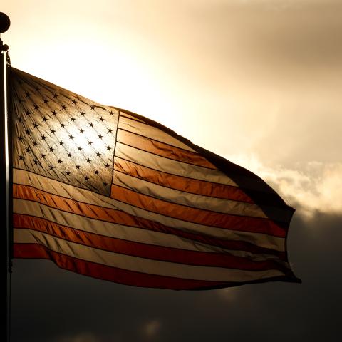 The sun sets behind an American flag flying at the Tear Drop 9/11 Memorial on May 12, 2024, in Bayonne, New Jersey. (Photo by Gary Hershorn/Getty Images)