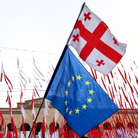 A protester waves Georgian and European Union flags in Tbilisi, Georgia, on May 28, 2024. (Photo by Giorgi Arjevanidze/AFP via Getty Images)