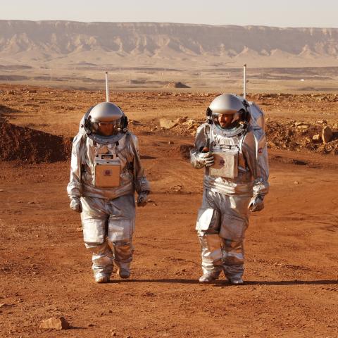 Astronauts from Europe and Israel walk in spacesuits during a training mission for planet Mars in the Negev desert on October 10, 2021. (Jack Guez/AFP via Getty Images)