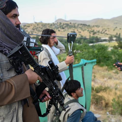 A Taliban security personnel holds his gun near the Qargha lake on the outskirts of Kabul on July 4, 2024. (Photo by Wakil Koshar / AFP via Getty Images)