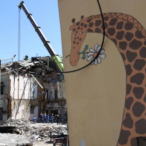 Emergency and rescue personnel clear the rubble of the destroyed building of Ohmatdyt Children's Hospital after a missile attack in Kyiv on July 9, 2024. (Anatolii Stepanov/AFP via Getty Images)