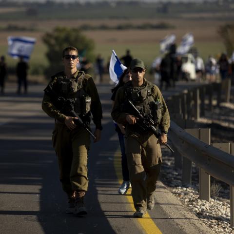 Israeli soldiers protect a march on July 17, 2024, in Kfar Azza, Israel. (Amir Levy via Getty Images)