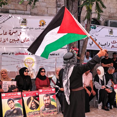 A man waves a Palestinian flag in the West Bank on July 9, 2024. (Zain Jaafar/AFP via Getty Images)