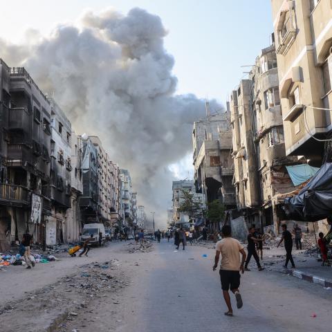 Palestinians rush toward a column of smoke after an Israeli strike in Gaza City on August 3, 2024. (Omar Al-Qattaa/AFP via Getty Images)