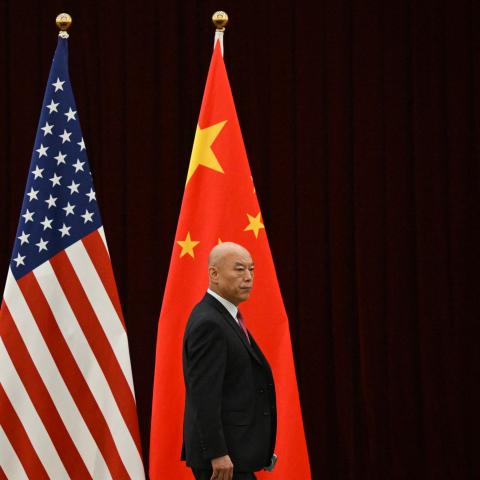 A man walks past China's and America's flags before a meeting between United States Treasury Secretary Janet Yellen and China's Vice Premier He Lifeng in Guangzhou, China, on April 5, 2024. (Pedro Pardo via Getty Images)