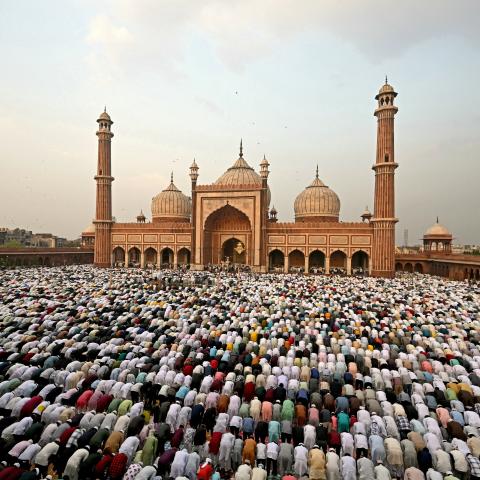 Muslim devotees offer Eid al-Fitr prayers in the old quarters of New Delhi on April 11, 2024. (Money Sharma/AFP via Getty Images)