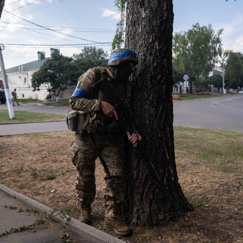 Ukrainian soldier of the 33rd assault battalion hides behind a tree after hearing the sound of a drone in the town center on August 16, 2024 in Sudzha, Russia. The fighting in the Kursk Oblast began on August 6, 2024, when the Armed Forces of Ukraine crossed the Russian-Ukrainian border near the city of Sudzha and began to advance deep into Russian territory, and in a few days took control of dozens of settlements in Kursk region. (Photo by Taras Ibragimov/Suspilne Ukraine/JSC "UA:PBC"/Global Images Ukraine