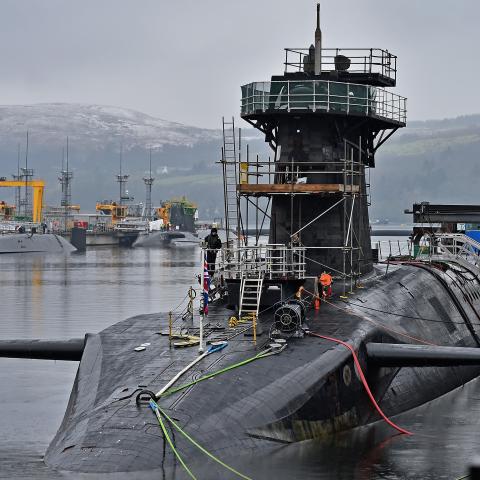 Royal Navy security personnel stand guard on HMS Vigilant at Her Majesty's Naval Base, Clyde on January 20, 2016 in Rhu, Scotland. HMS Vigilant is one of the UK's fleet of four Vanguard class nuclear-powered ballistic missile submarines carrying the Trident nuclear missile system. A decision on when to hold a key Westminster vote on renewing Trident submarine class is yet to be decided senior Whitehall sources have admitted. (Photo by Jeff J Mitchell/Getty Images)