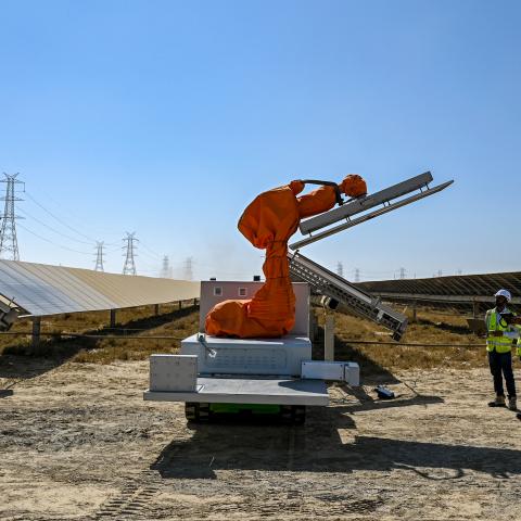 Workers install a solar panel at the Adani Group–owned Khavda Renewable Energy Park in Khavda on January 12, 2024. (Punit Paranjpe/AFP via Getty Images)