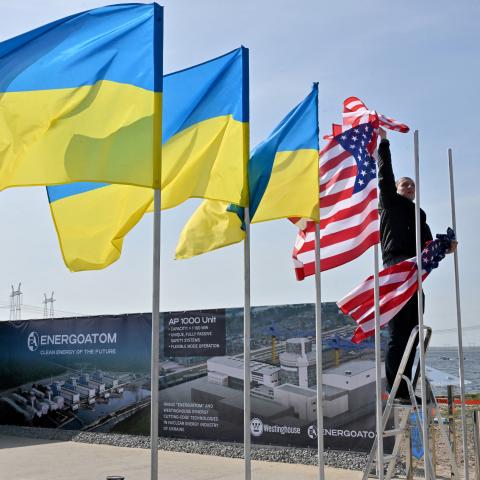 An employee hangs flags near Khmelnytsky, Ukraine, on April 11, 2024. (Sergei Supinsky/AFP via Getty Images)