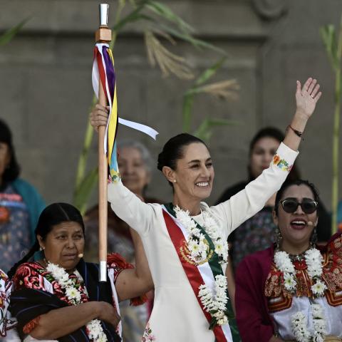 Mexico's new President Claudia Sheinbaum raises the ceremonial staff in Mexico City on October 1, 2024. (Carl De Souza/AFP via Getty Images)