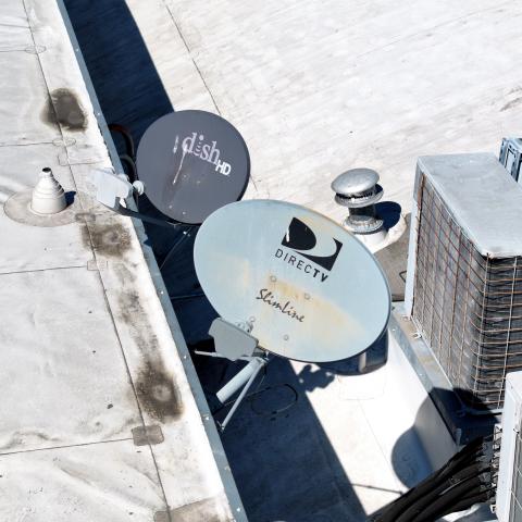 Dish Network and DirecTV satellite dishes are mounted to the roof of a building on October 1, 2024, in San Rafael, California. (Justin Sullivan via Getty Images)