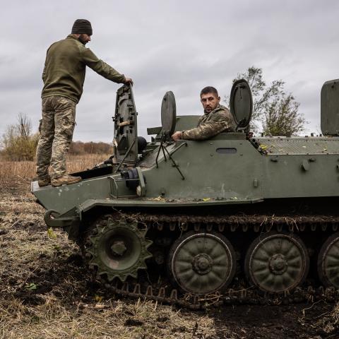 Two Ukrainian army mechanics repair a broken MT-LB in Kharkiv, Ukraine, on October 25, 2024. (Fermin Torrano/Anadolu via Getty Images)