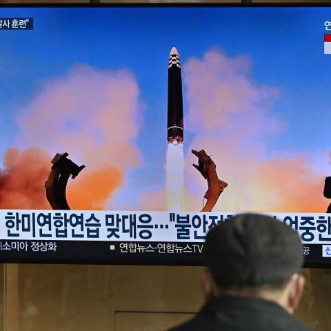 A television news screen in Seoul, South Korea, on March 17, 2023, shows a picture of North Korea's test-firing of a Hwasong-17 intercontinental ballistic missile. (Jung Yeon-je/AFP via Getty Images)
